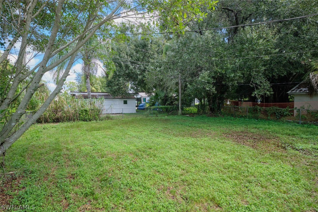 1322 Old Bridge Road North Fort Myers, FL 33917 - Photo 13 of 15 a backyard of a house with a garden and barbeque oven