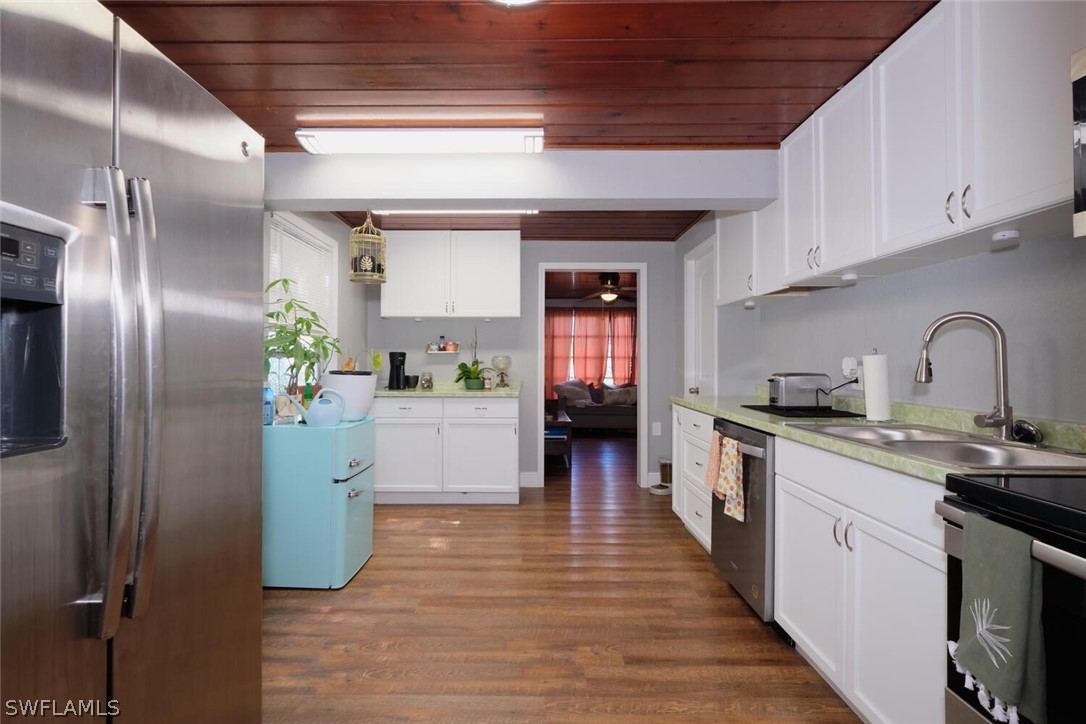 1322 Old Bridge Road North Fort Myers, FL 33917 - Photo 5 of 15 a kitchen with refrigerator and cabinets
