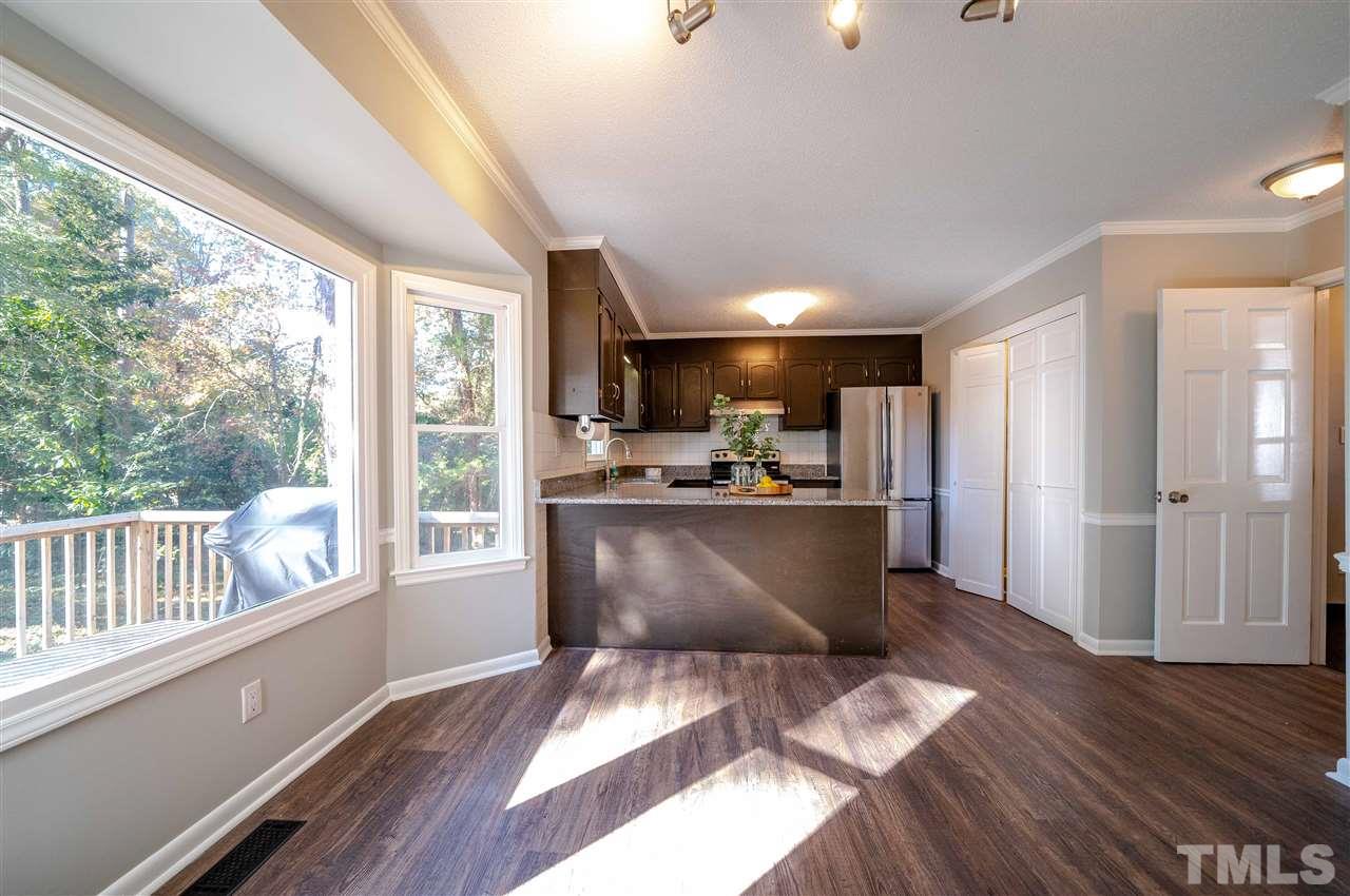 516 Merrie Road Raleigh, NC 27606 - Photo 7 of 29 a view of kitchen with furniture and wooden floor