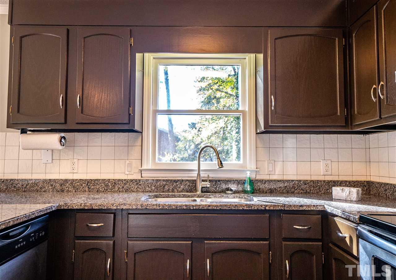 516 Merrie Road Raleigh, NC 27606 - Photo 10 of 29 a kitchen with granite countertop a sink and a window