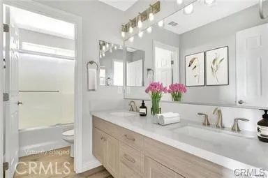 a bathroom with a granite countertop sink mirror and a shower