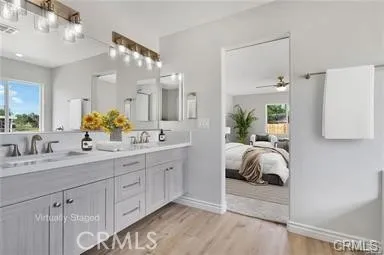 a spacious bathroom with a double vanity sink and a mirror