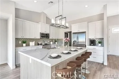 a view of kitchen with sink and refrigerator