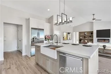 a kitchen with stainless steel appliances a sink and a refrigerator