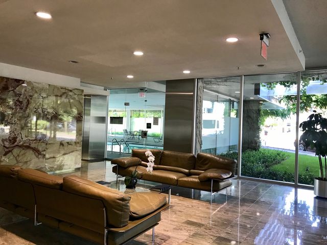 a view of a patio with table and chairs and potted plants