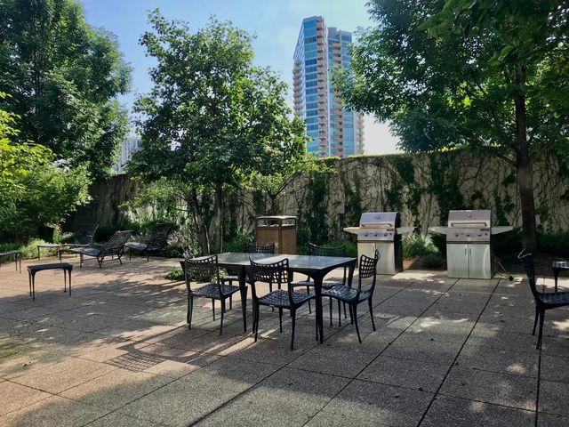 a kitchen with stainless steel appliances granite countertop a sink and a large window