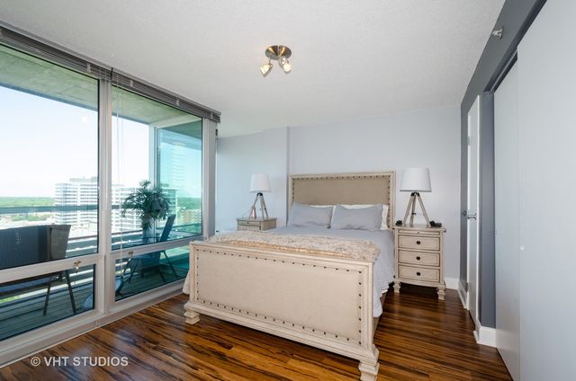 a room with a bed and wooden floor