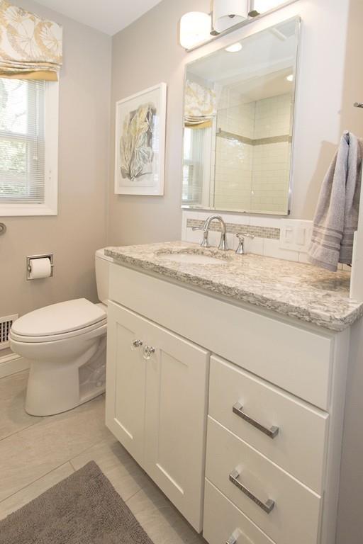 5 Patony Road Framingham, MA 01701 - Photo 20 of 22 a bathroom with a granite countertop toilet sink and mirror