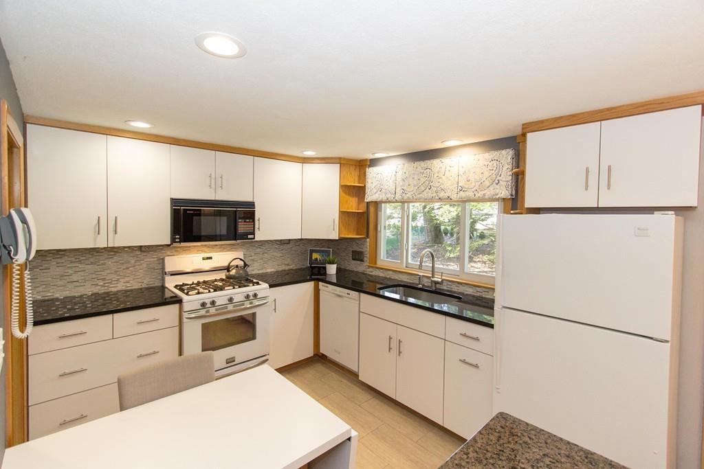 5 Patony Road Framingham, MA 01701 - Photo 6 of 22 a kitchen with white cabinets and white appliances