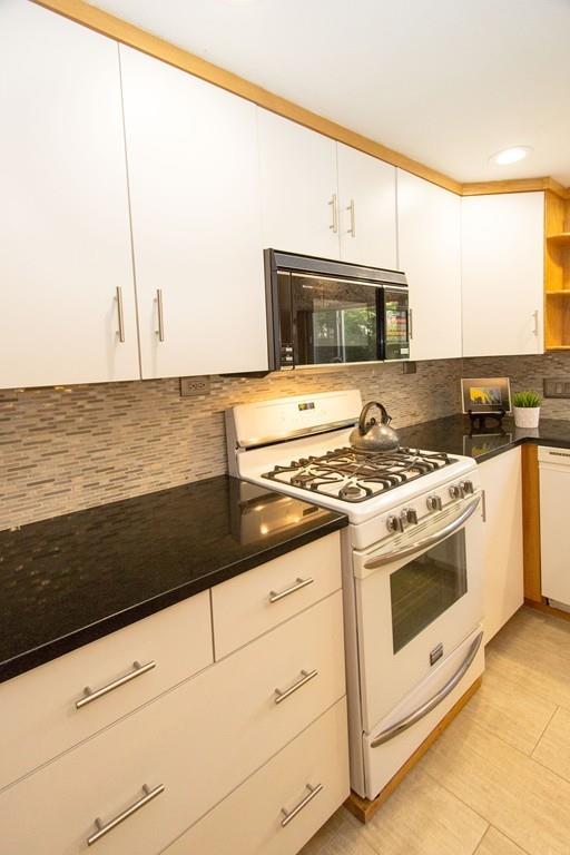 5 Patony Road Framingham, MA 01701 - Photo 9 of 22 a kitchen with granite countertop a stove sink and cabinets