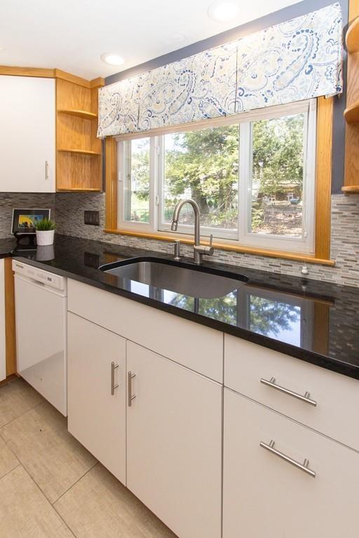 5 Patony Road Framingham, MA 01701 - Photo 10 of 22 a kitchen with granite countertop white cabinets and a large window