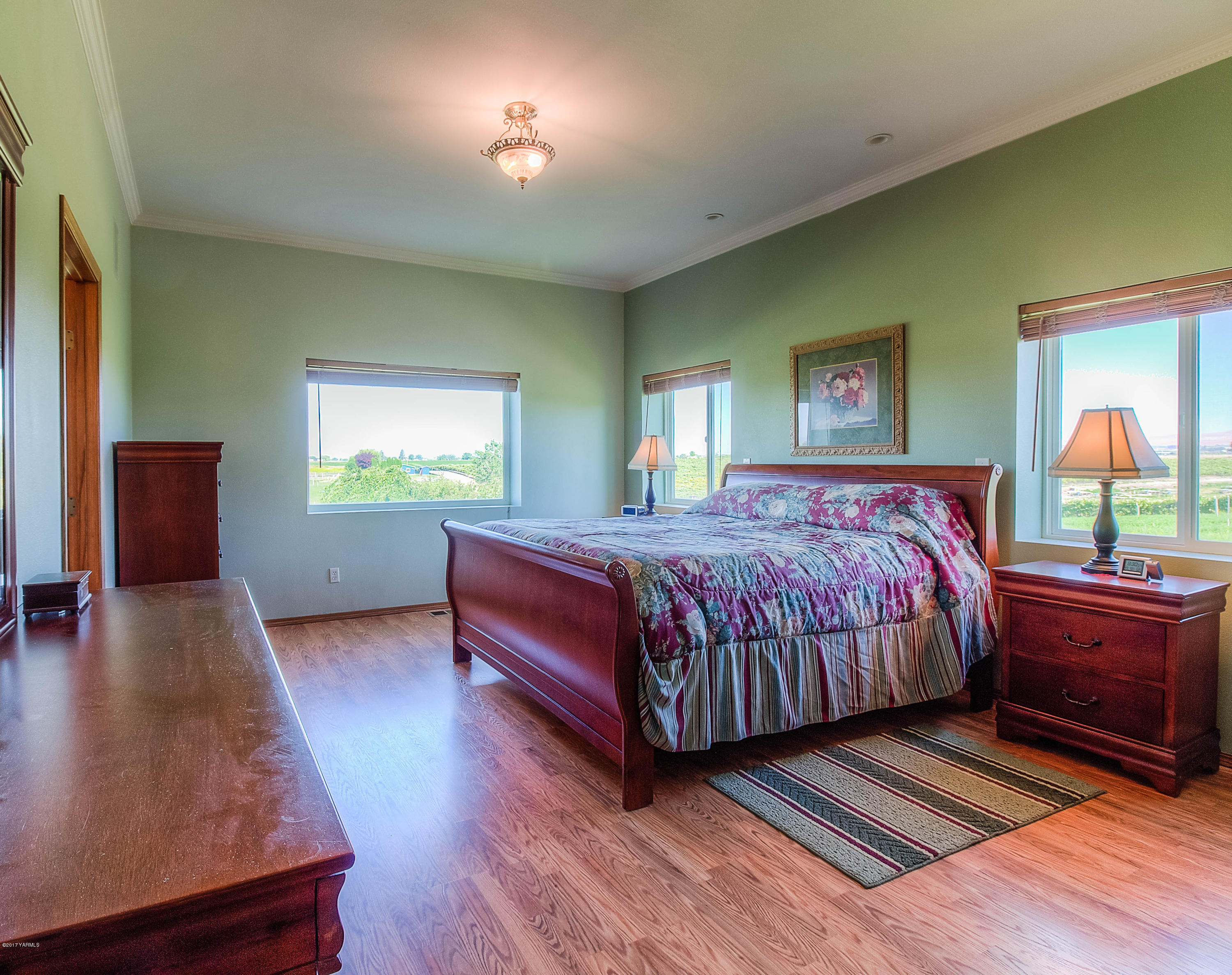 765 Lowry Road Outlook, WA 98938 - Photo 13 of 31 a bedroom with a bed lamps and window