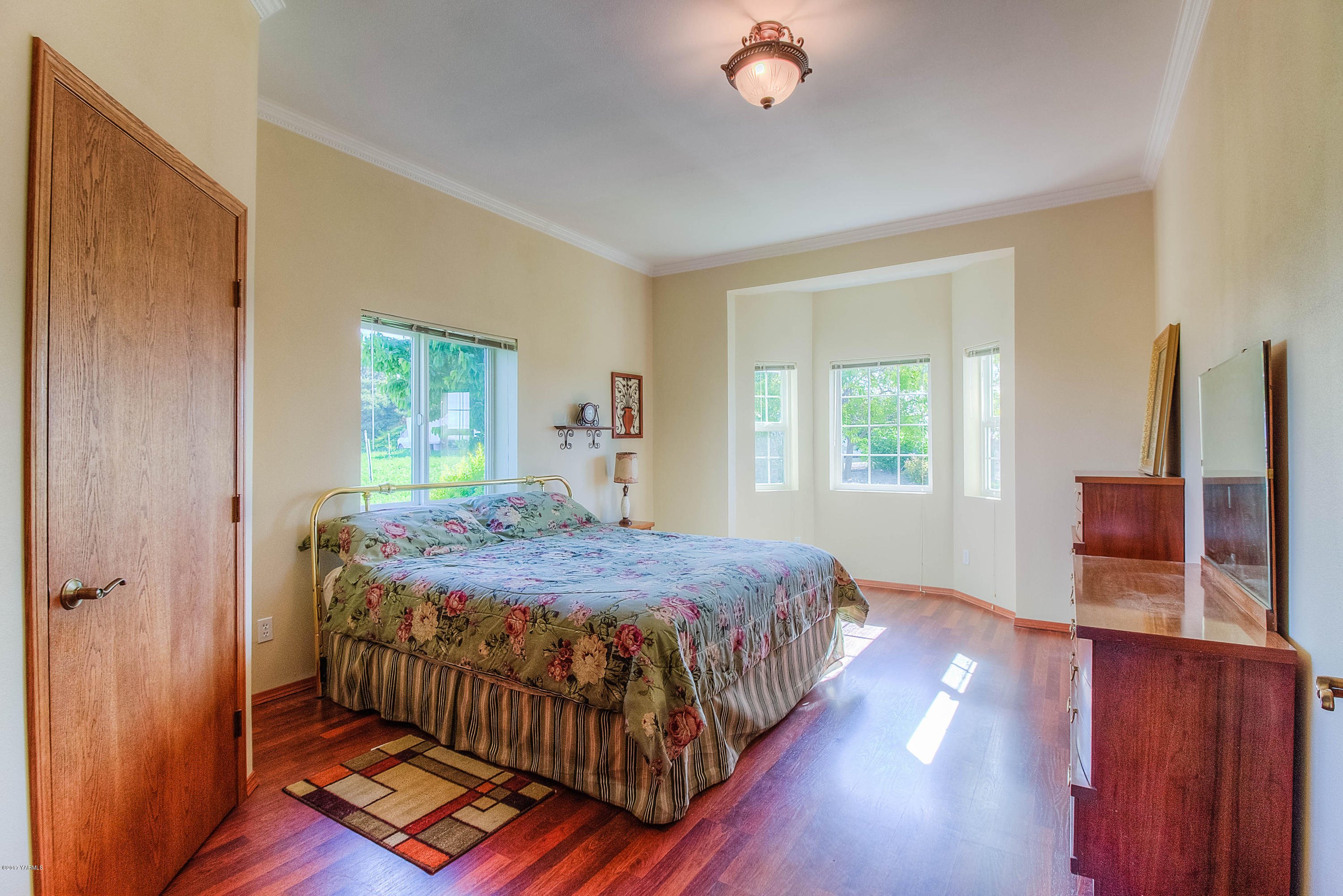 765 Lowry Road Outlook, WA 98938 - Photo 18 of 31 a bedroom with a bed and wooden floor