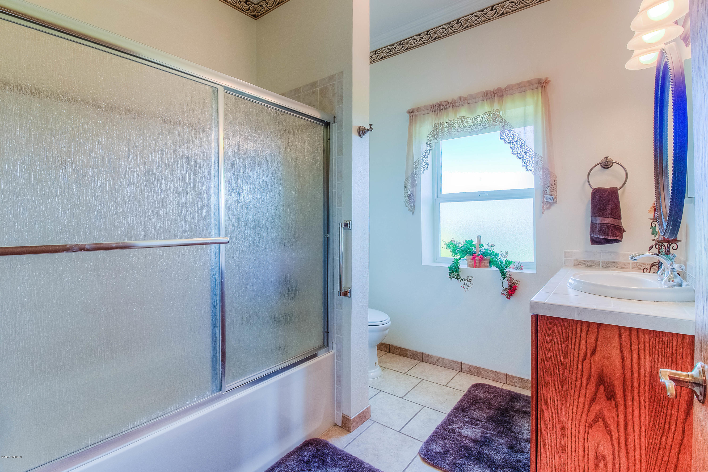 765 Lowry Road Outlook, WA 98938 - Photo 19 of 31 a bathroom with a granite countertop sink and a mirror