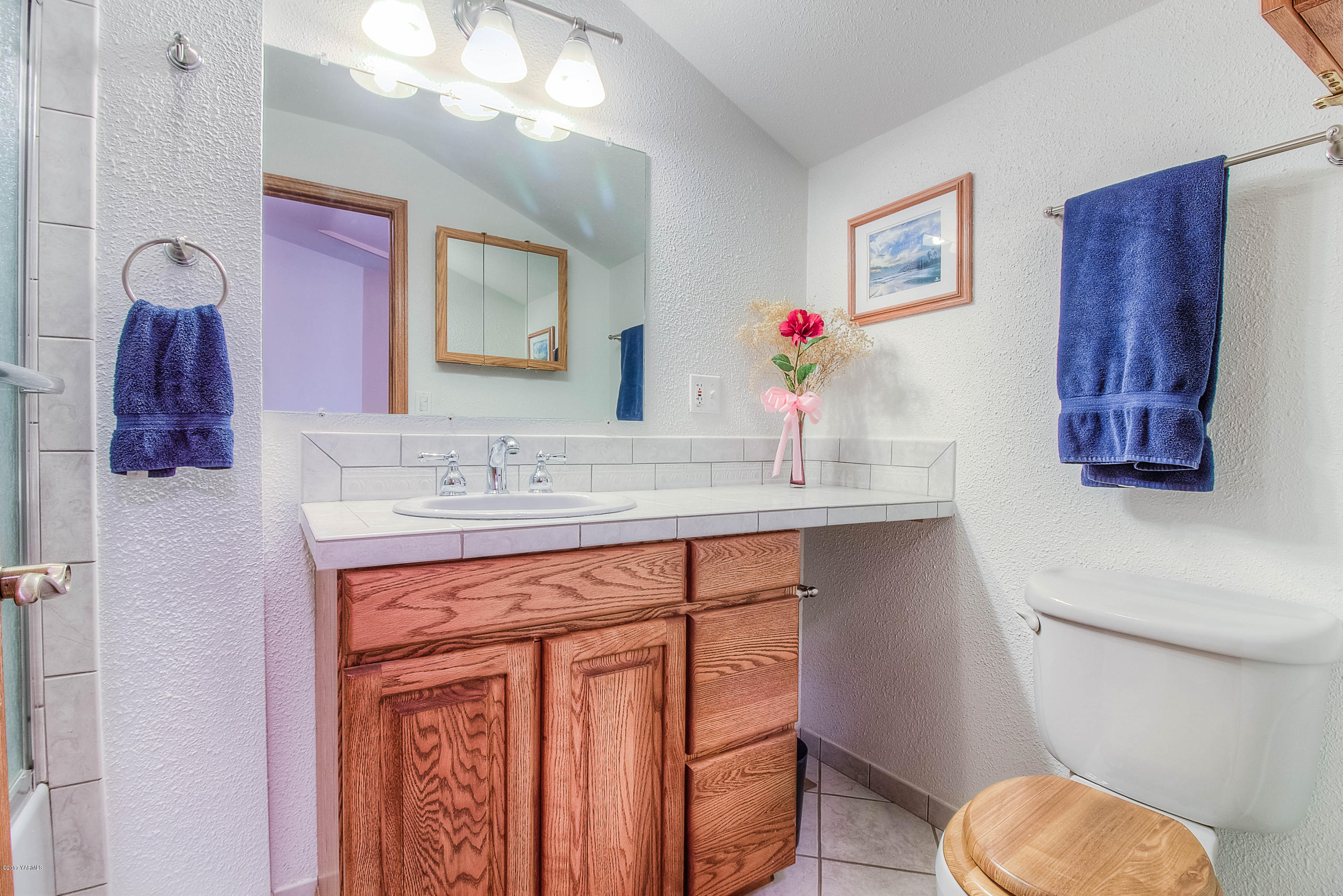 765 Lowry Road Outlook, WA 98938 - Photo 26 of 31 a bathroom with a granite countertop toilet sink and mirror