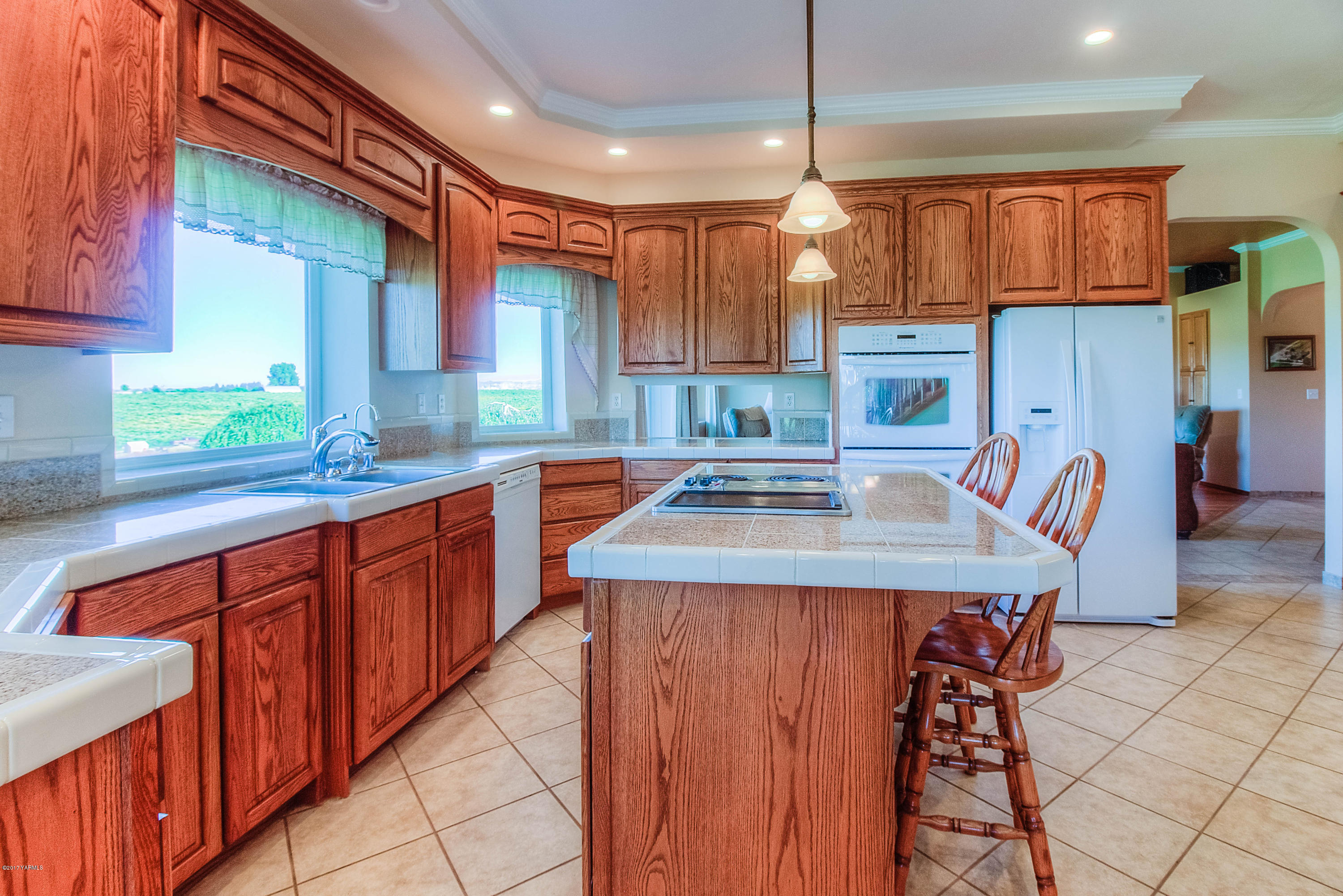 765 Lowry Road Outlook, WA 98938 - Photo 7 of 31 a kitchen with stainless steel appliances granite countertop a sink a stove and a wooden cabinets