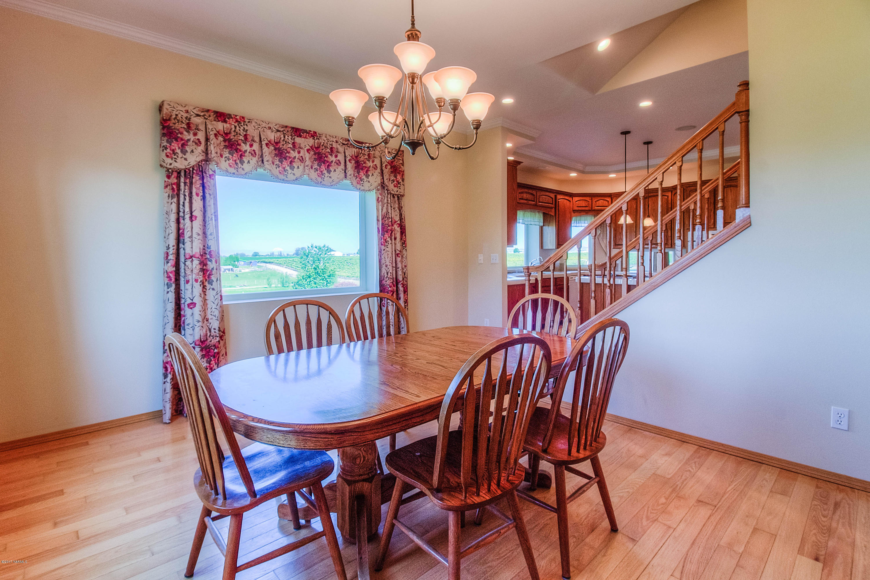 765 Lowry Road Outlook, WA 98938 - Photo 10 of 31 a dining room with furniture a chandelier and wooden floor