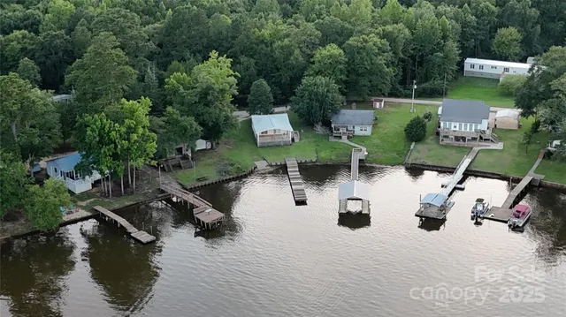 an aerial view of a house with swimming pool and patio