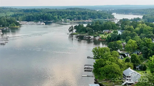 a view of river covered by trees and buildings