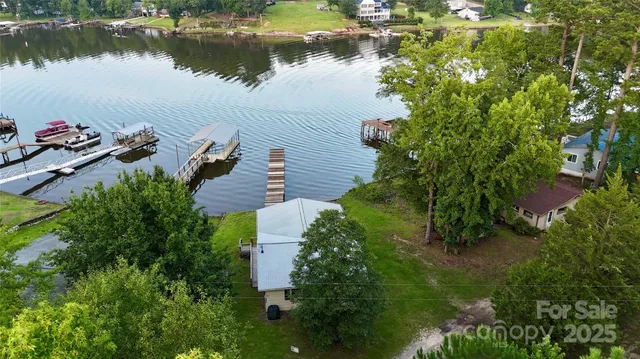a backyard of a house with lots of green space and lake view