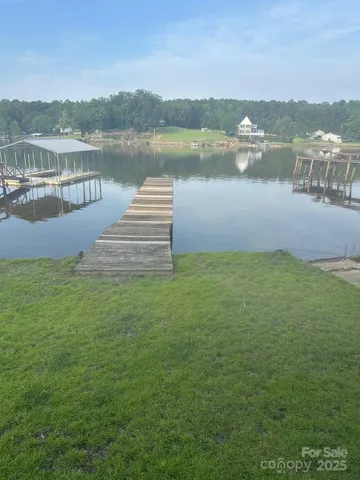 a view of a lake with houses in the back