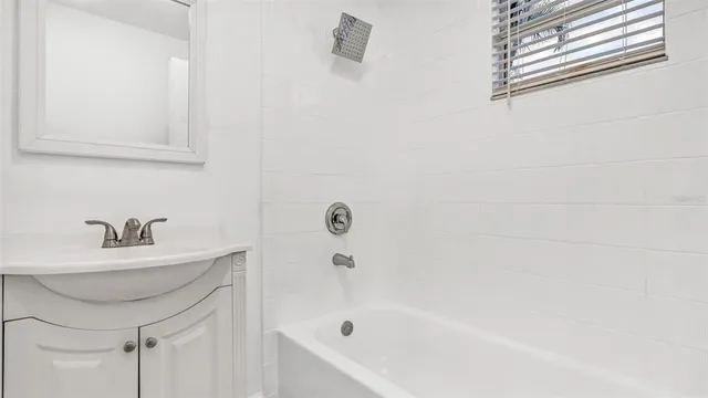 a bathroom with a sink a bathtub and a shower
