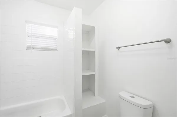 a bathroom with a shower and a toilet