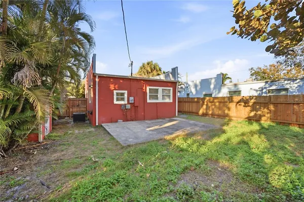 a view of a yard in front of a house with large trees