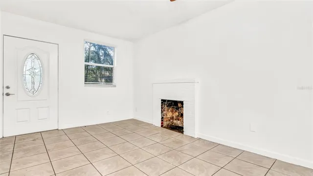 a view of a livingroom with wooden floor and a fireplace