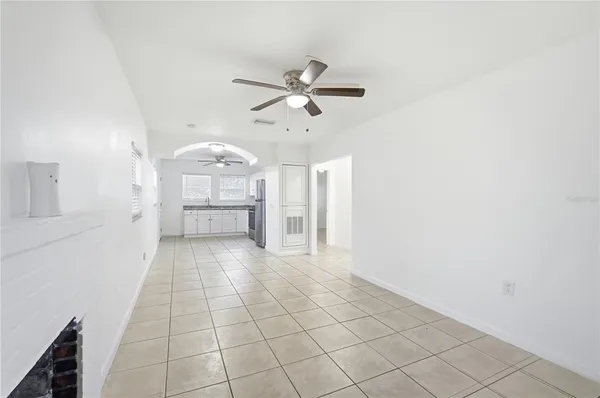 a view of a kitchen with a sink and a refrigerator