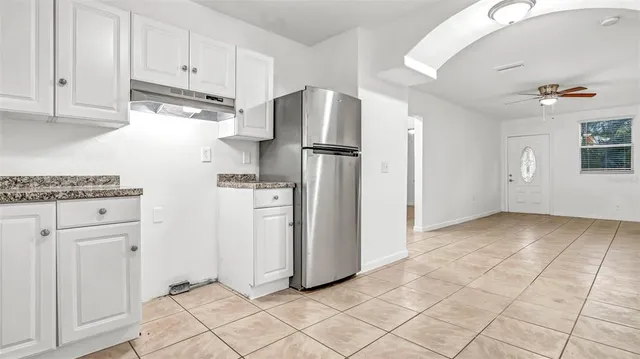 a view of a kitchen with refrigerator and cabinet