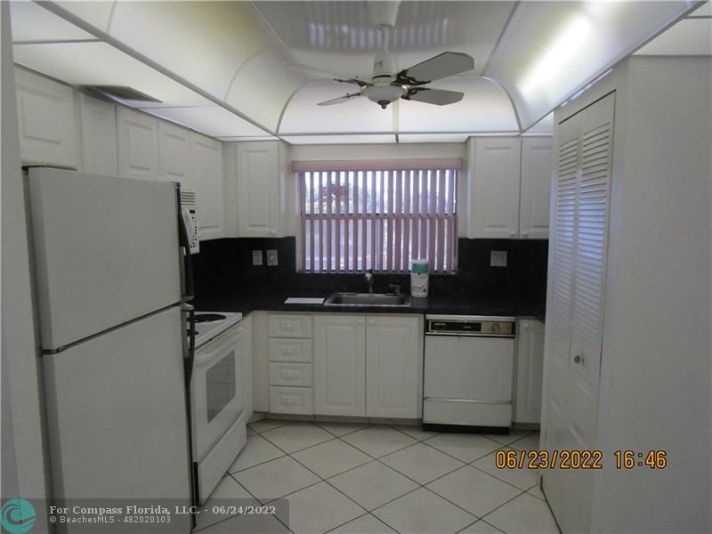 a kitchen with a refrigerator a stove a microwave and cabinets