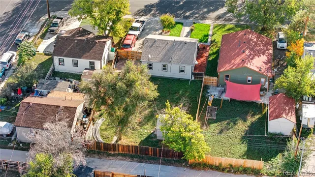 an aerial view of residential houses with outdoor space and street view