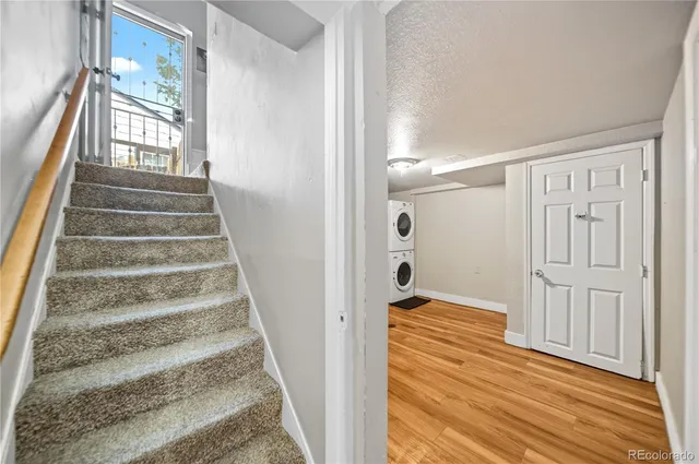 a view of a hallway with wooden floor and entryway