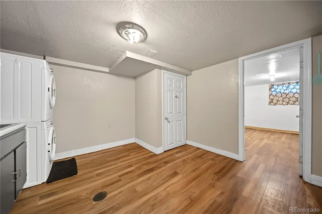 a view of an empty room and wooden floor