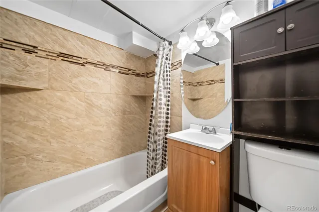 a bathroom with a bathtub a mirror and shower