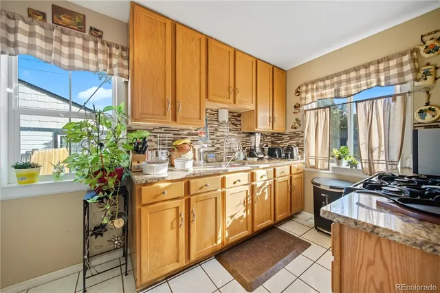 a kitchen with a sink stove and cabinets