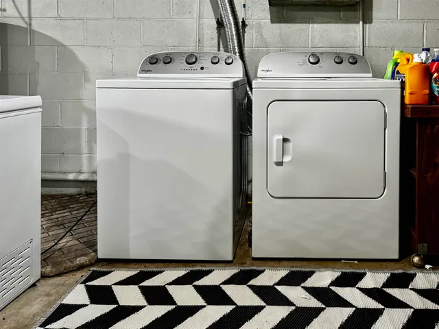 a view of a storage and utility room with washer and dryer