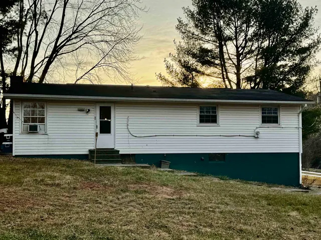 a backyard of a house with lots of trees