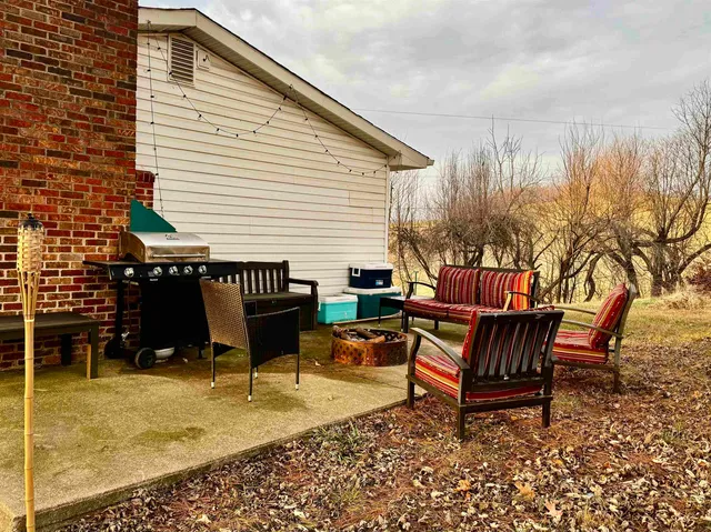 a backyard of a house with table and chairs