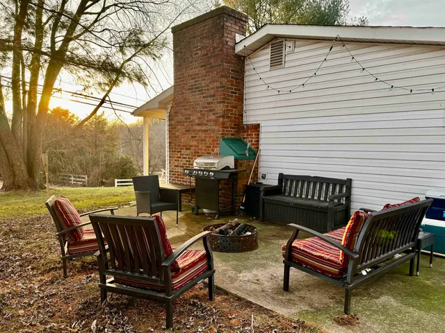a view of a patio with a table and chairs