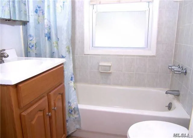 a bathroom with a sink a toilet and bathtub