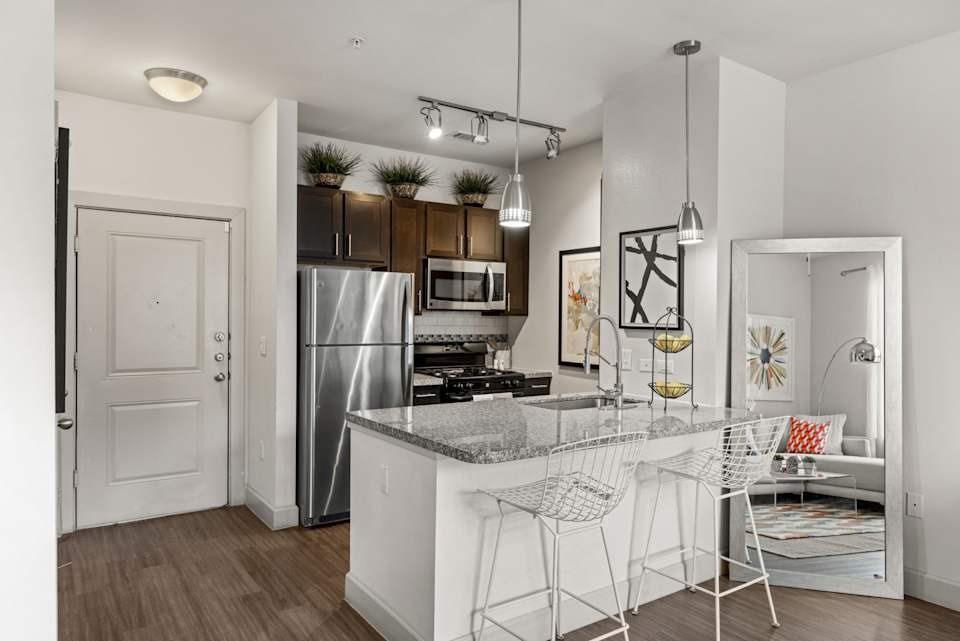 8800 South 1st Street, Unit 835 Austin, TX 78748 - Photo 6 of 20 a kitchen with stainless steel appliances kitchen island granite countertop a refrigerator and a sink