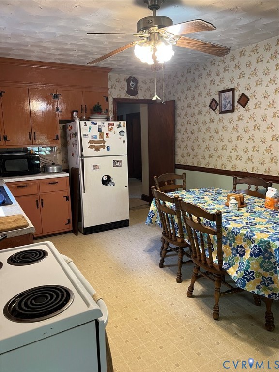 6809 River Road Petersburg, VA 23803 - Photo 6 of 9 a kitchen with stainless steel appliances granite countertop a stove top oven a sink a dining table and chairs with the floor