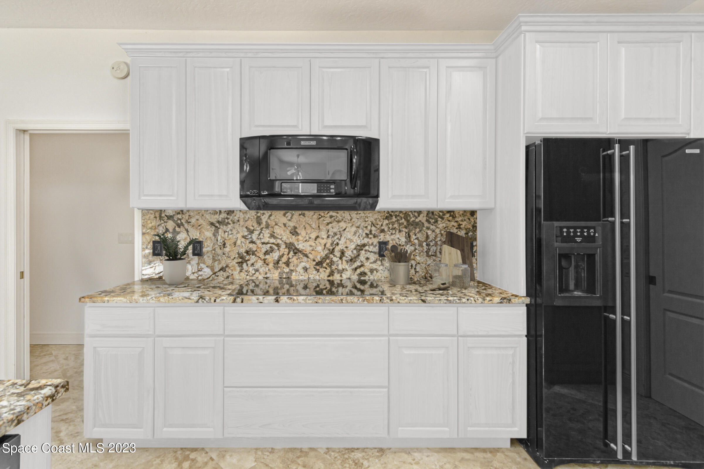 271 Deer Run Road Palm Bay, FL 32909 - Photo 14 of 61 a kitchen with stainless steel appliances granite countertop a refrigerator stove and microwave