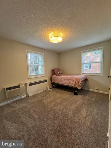 a spacious bedroom with a bed and a window