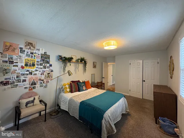 a bedroom with a bed and a couch