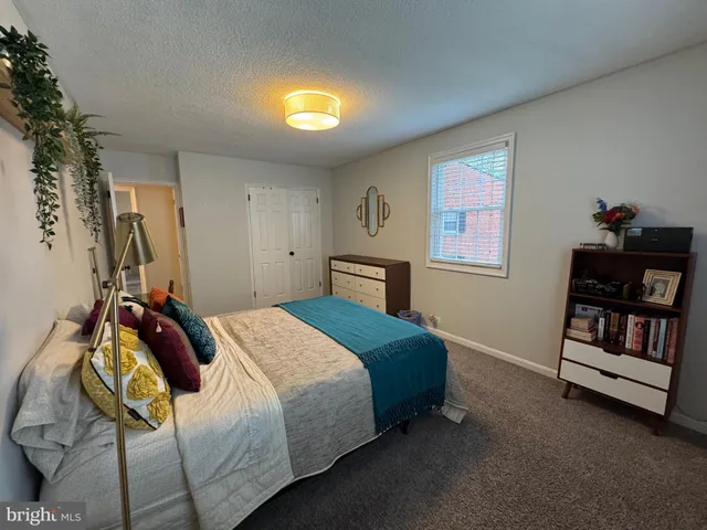 a bedroom with a bed and dresser