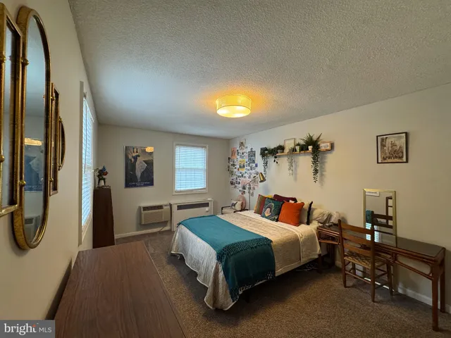 a bedroom with a bed and a table in it