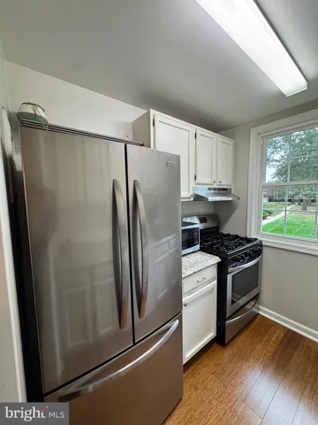 a kitchen with stainless steel appliances a refrigerator sink and microwave